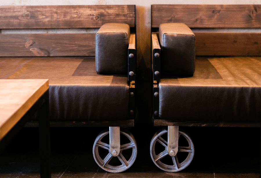Two sofas on castor wheels used in the hospitality industry to ensure efficiency in transporting the sofas.