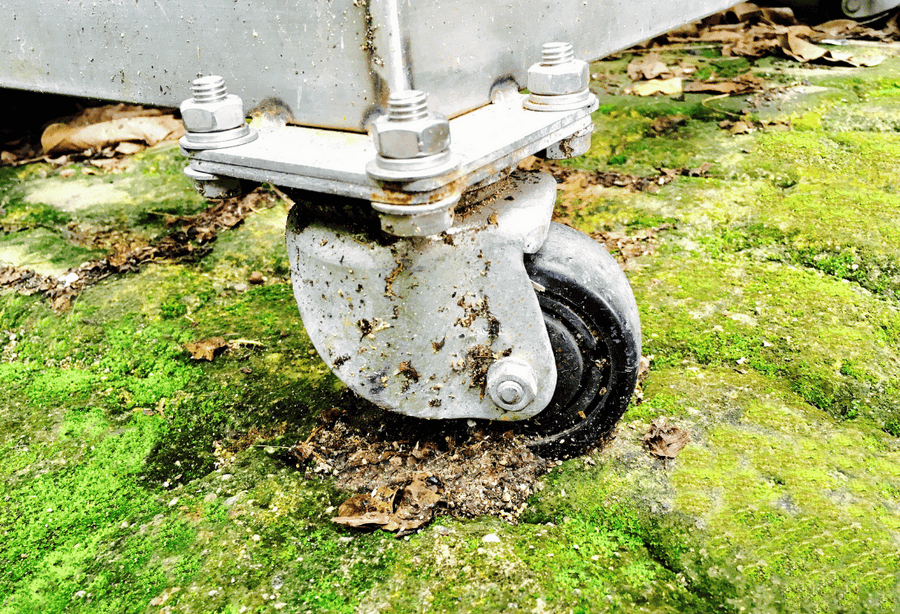 A metal castor wheel being used to move through cold winter conditions.
